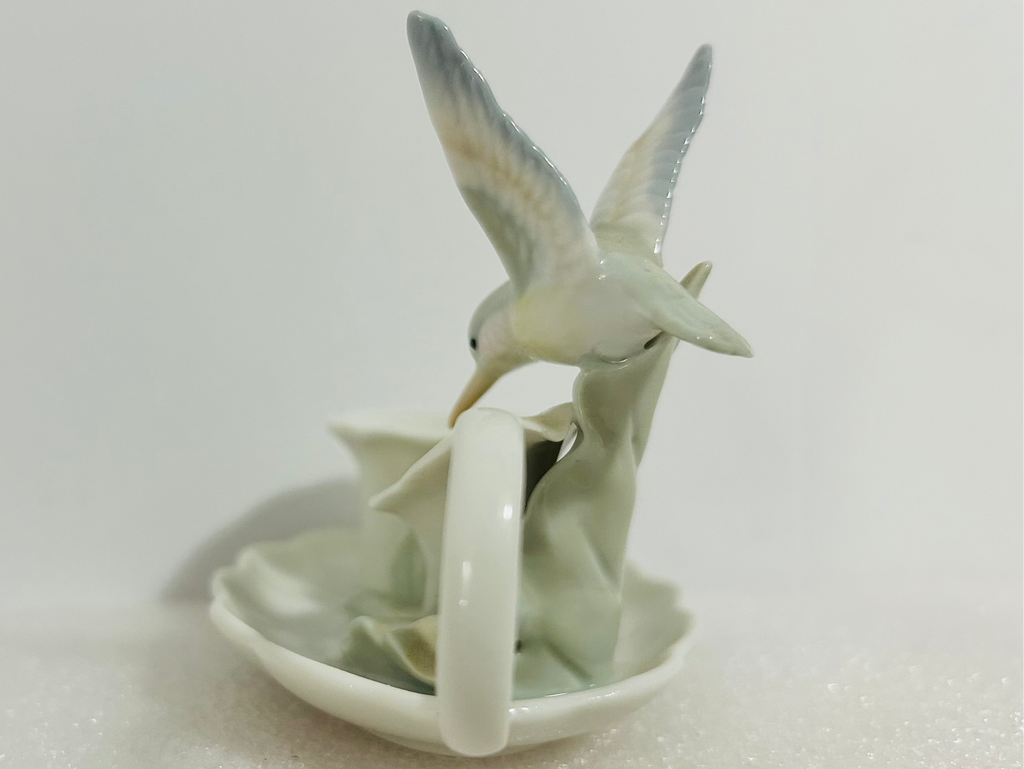 Ceramic teapot with two birds on a white background