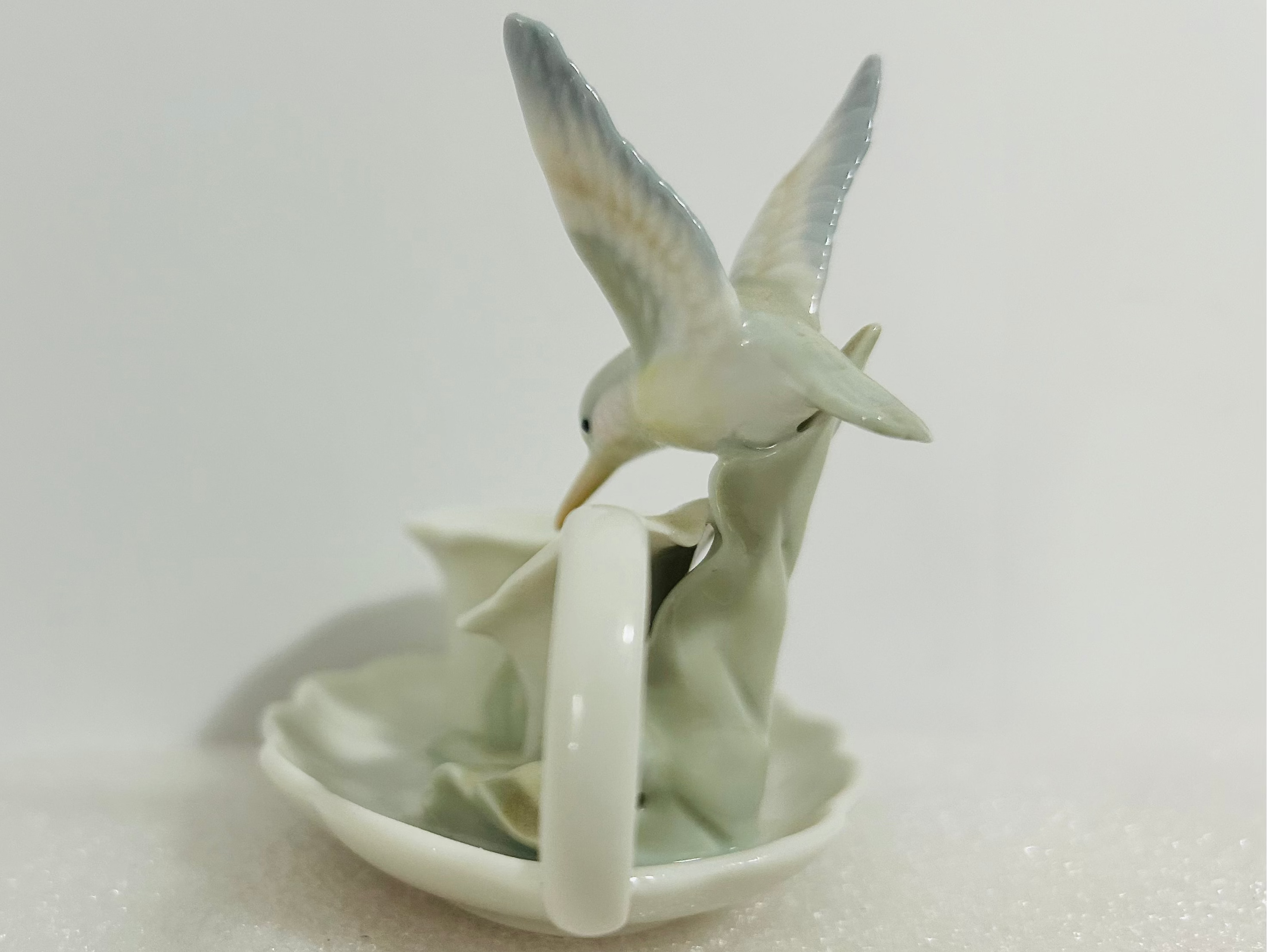 Ceramic teapot with two birds on a white background