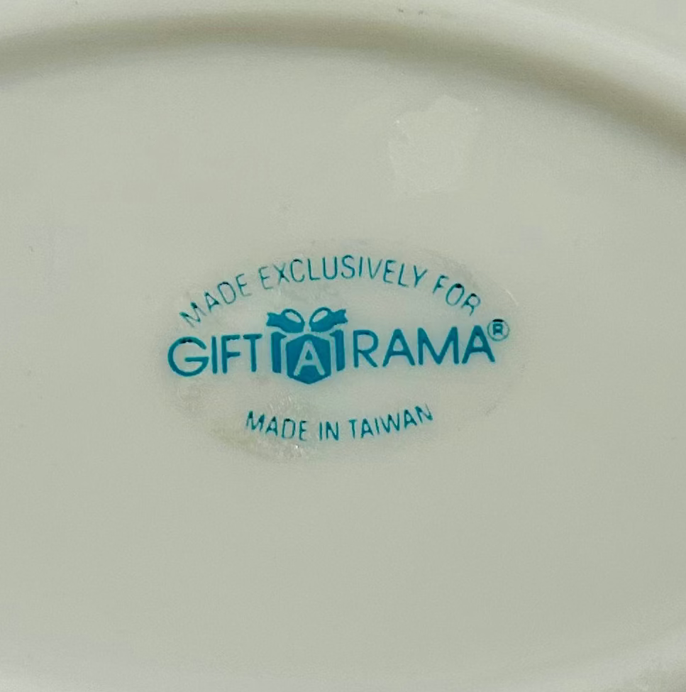 White ceramic dish with a handle on a light gray background